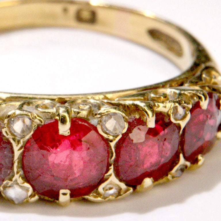 Five-stone Victorian ruby ring with filigree gold setting.  Eight tiny diamonds enhance the setting.  Hallmarked.