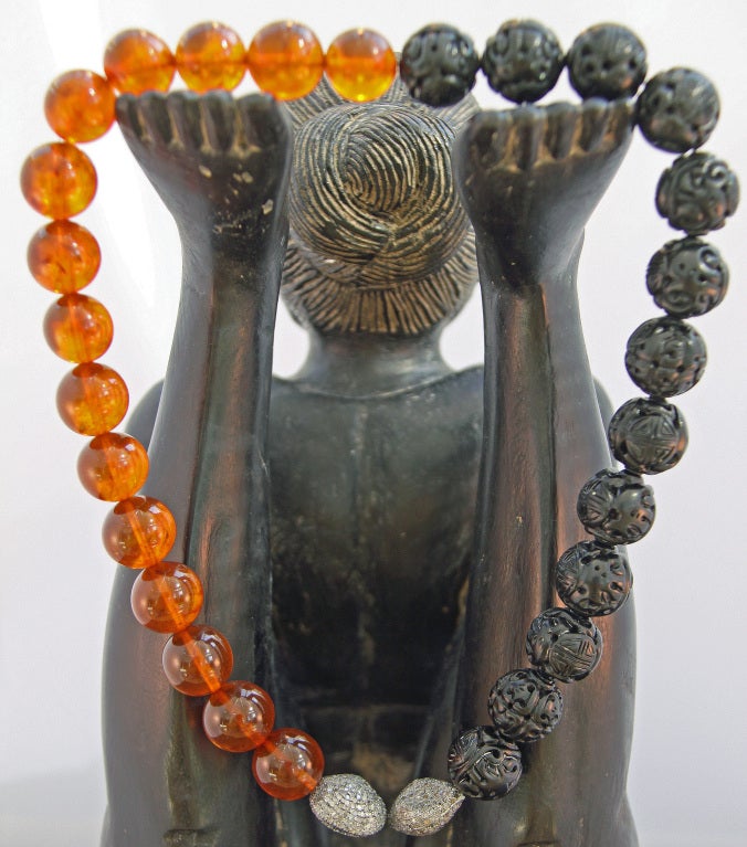 Vintage Russian amber beads paired with hand-carved black jet beads and two diamond studded beads.

Overall length: 20