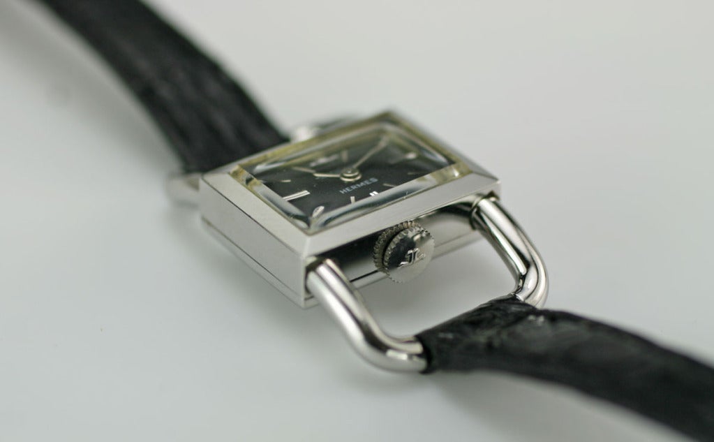 This is a beautiful vintage Jaeger-LeCoultre retailed by Hermes in excellent condition. Both the black dial and the back of the case are marked Hermes. The strap is made by Jaeger. Lug to lug lengh is 33.9mm Strap is 10mm