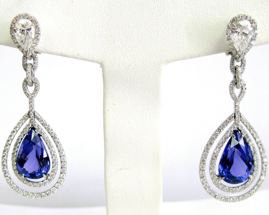 Exquisitely crafted in platinum and diamonds, these double frame tanzanite earrings feature two pear shape diamonds totaling 2.02 carats, pave diamonds totaling 2.57 carats, and two big beautiful tanzanite pear shape stones totaling 14.49 carats.