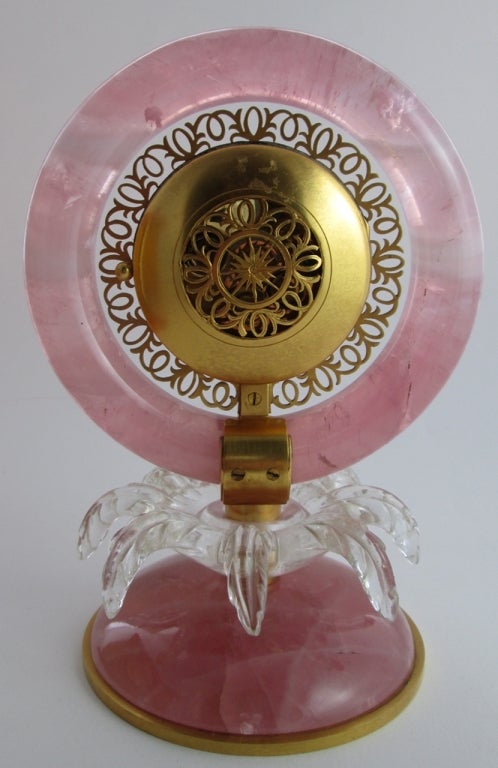 PLEASE NOTE: OUR PRICE IS FULLY INCLUSIVE OF SHIPPING, IMPORTATION TAXES & DUTIES

Art Deco Pink Quartz & Rock Crystal Table Clock, By BLACK STARR & GORHAM

The circular silvered and gold dial with black Roman numerals mounted in gilt metal,