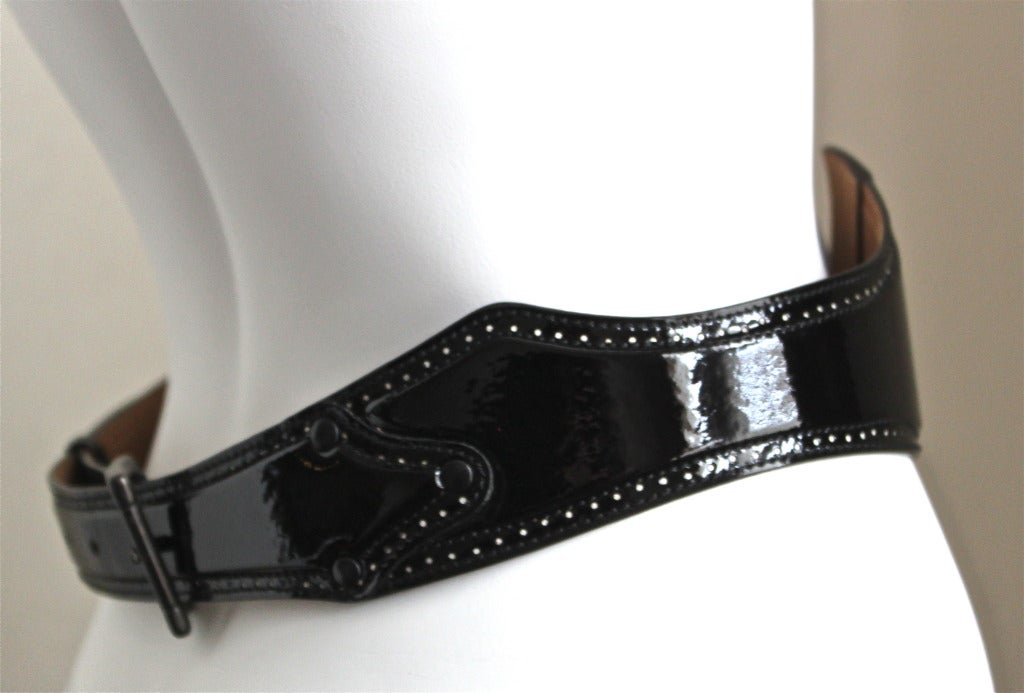 Jet black patent leather belt with white perforated accents from Azzedine Alaia. Labeled a FR size 85 (US 34