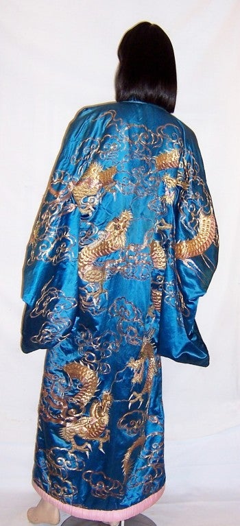 This is a superb, early 20th century, deep turquoise silk, formal Japanese  kimono with five, three-toed dragons masterfully embroidered in  three hues of gold metallic thread with white and pink accents.  The opulent couched metallic embroidery is