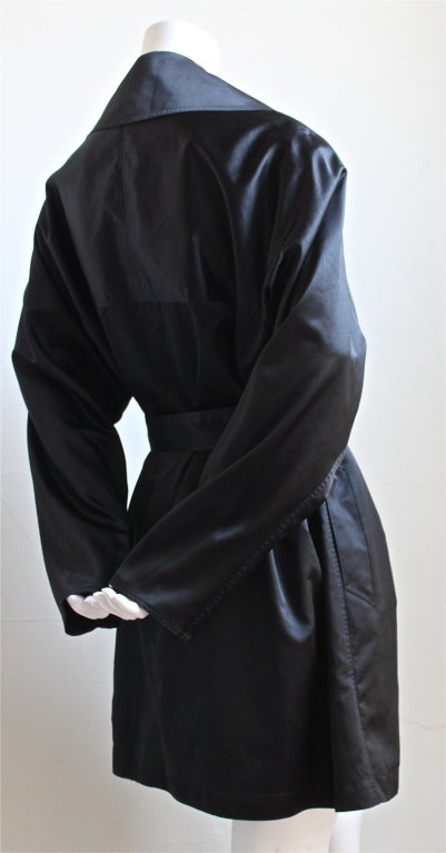 Jet black sateen trench from Azzedine Alaia dating to 1992. Trench fits a size 6-10 due to oversized fit. Made in France. Very good condition (light abrasions mostly to interior).
