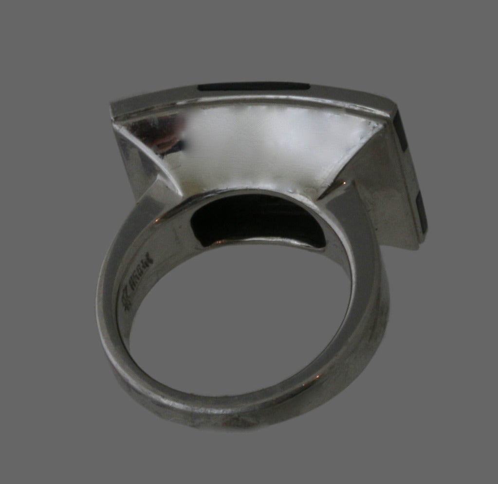 This is stunning and unusual handcrafted ring featuring an elongated rectangle set with a checked pattern of inlaid onyx and platinum. Designed in the 1980's by the renowned architect Alessandro Mendini for Tannler, Switzerland, considered one of