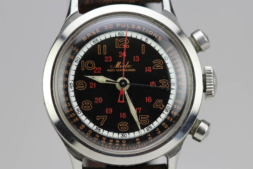 This is a rare find, a stainless steel Mido Multi-Centerchrono wristwatch. The case is stainless steel with round pump chronograph pushers, screw down case back, lapidated lugs, with an original black dial, red 24-hour markings with white