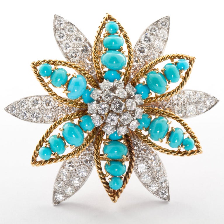 Your perfect winter accessory.  A David Webb original star shaped flower brooch made of round brilliant diamonds and oval cabochon turquoise set in18k gold and platinum. Contains ~9.15 carats of diamonds. Measures 2-1/8