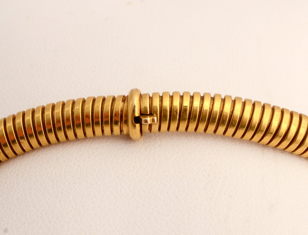 Flexible gold tubogas necklace that can be worn equally well on its own or with a pendant. Measurements are 16 1/2
