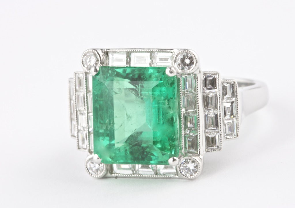 The Emerald weighs 5.28 carats and is certified by GIA as Colombian. Set in a Sophia D platinum ring with approximately 1.00 carat of diamonds. Deep green color and a beautifully designed ring. 

Ring size 6 1/2 and can be re-sized.