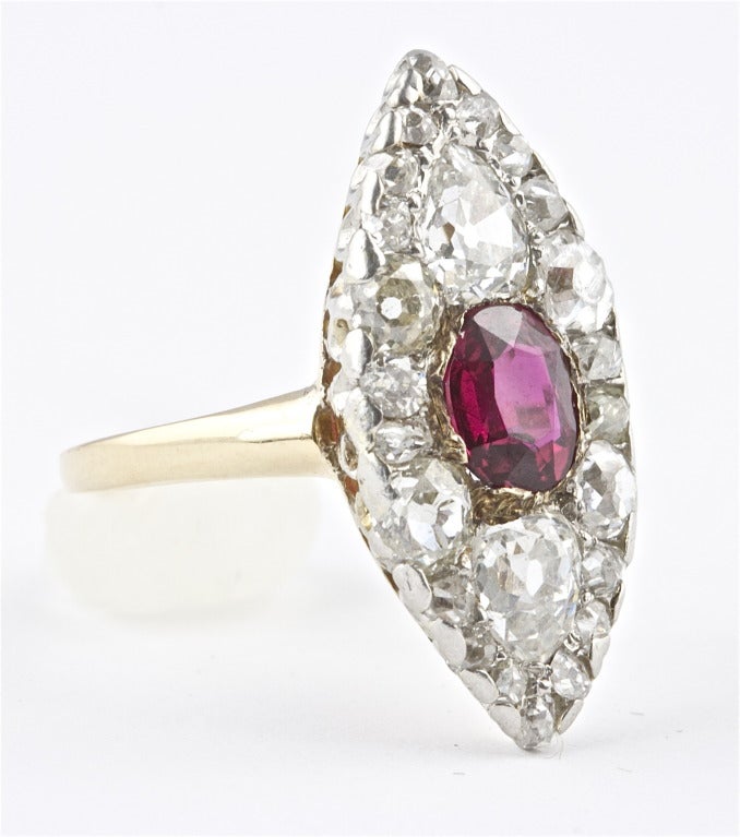 The Burma looking ruby weighs approximately 1.20 carats. There is a GIA certificate stating the ruby is from Thailand and has no indications of heating.  The ring is set with 2 old European cut pear shapes that weigh approximately 1.00 carat. Total