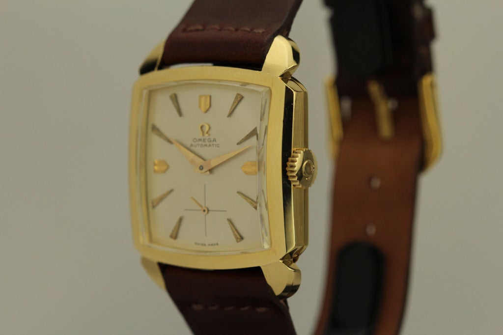 This is a mint example of an automatic oversized square Omega from the 1950s in 18k yellow gold.   This watch is a real time capsule with an unpolished case  and a minty dial.    This form does not not come up for sale very often and when it does