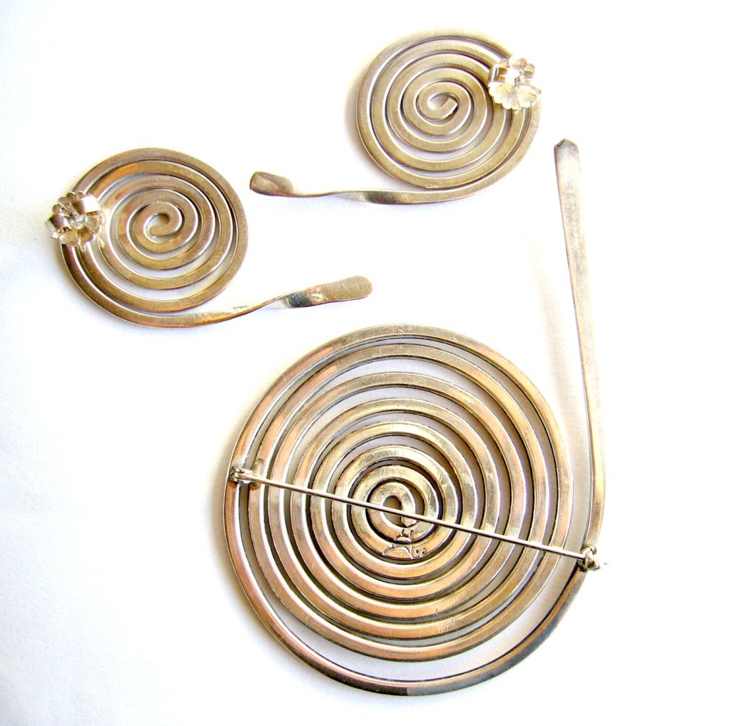 A large scale, sterling silver coiled snake brooch and earrings set of Southwest origin.  Brooch measures 4