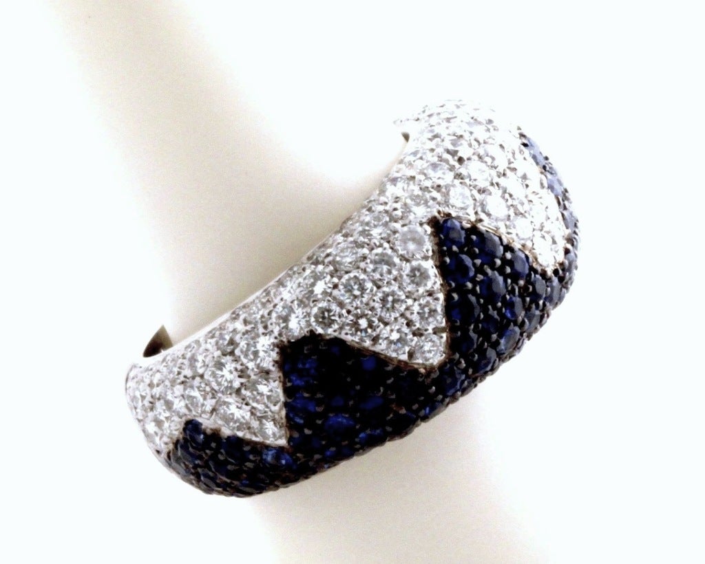 (Retail $23,850.00)

This 18K white gold, blue sapphire and diamond ring from the master jewelers at Chopard is simply splendid! The rounded, thick shape is gorgeous and bold while the design is playful and beautiful. Hundreds of blue sapphires