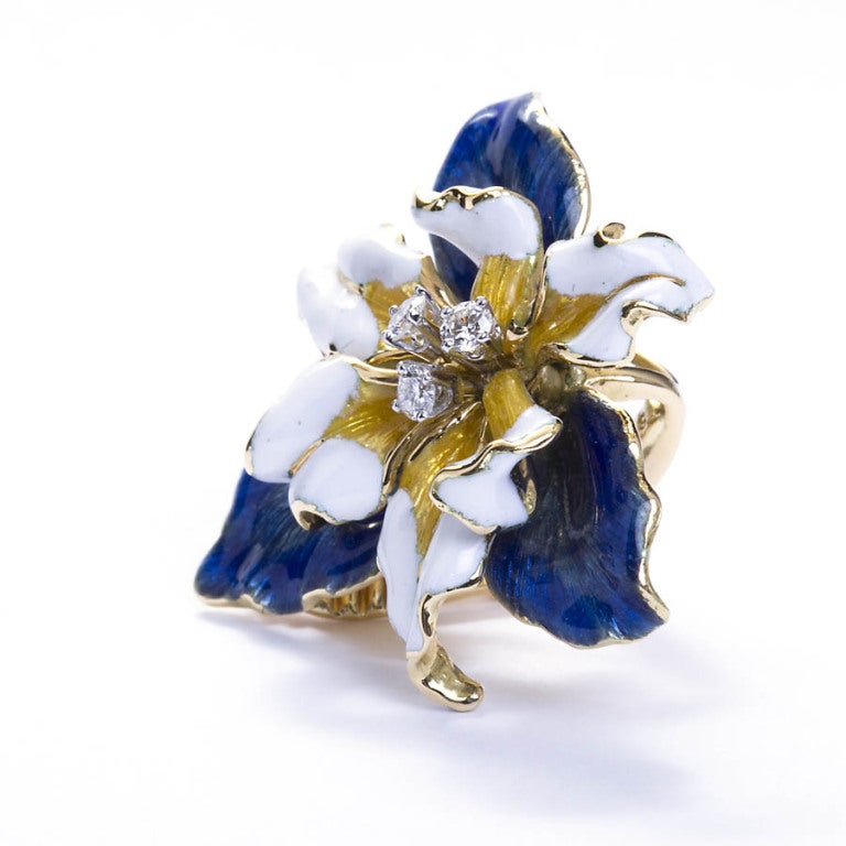 Hand formed delicate lily petals in translucent blue enamel on 18k yellow gold and white enamel on gold with diamond accents by David Webb. Signed DAVID WEBB.
1 3/8