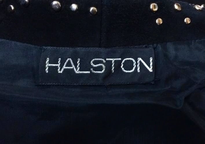 Jet black incredibly soft suede wrap jacket with hundreds of round flat silver tone studs from Halston dating to the 1970s. Can be worn open or with belt. Studs on both sides of neckline.  Best fits a size 4-8. Measures 36-40