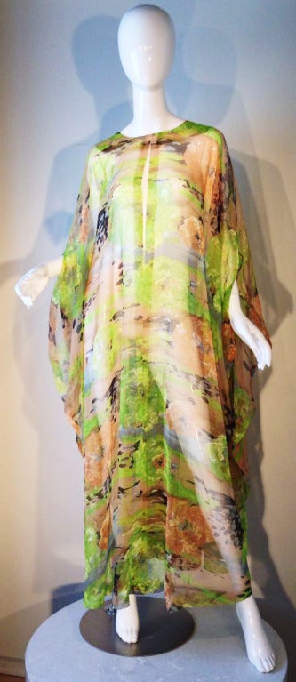 A fine vintage ethereal silk print chiffon caftan. Sheer item slips over head with vented front chest and arm slits. One size fits all with no closures. Unlabeled.