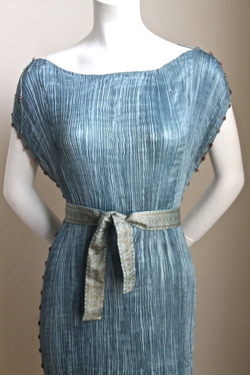 Phenomenal aquamarine blue pleated silk 'Delphos' gown with terra cotta colored Venetian speckled glass beads and stamped gold silk belt from Mariano Fortuny dating to the 1920's. Dress has a very early tape label at shoulder which indicates it is