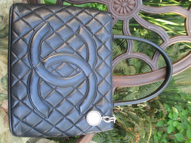 Chanel Black Caviar Lambskin Matalasee Large CC Logo Medallion Tote Bag.
9 1/2 