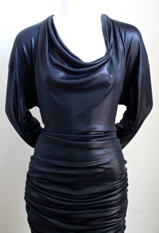 Metallic black slightly dress with rushing from Patrick Kelly dating to the 1980's. Fits a US 6-8. Measurements are difficult to take because the dress is designed to drape. The bust is approximately 38