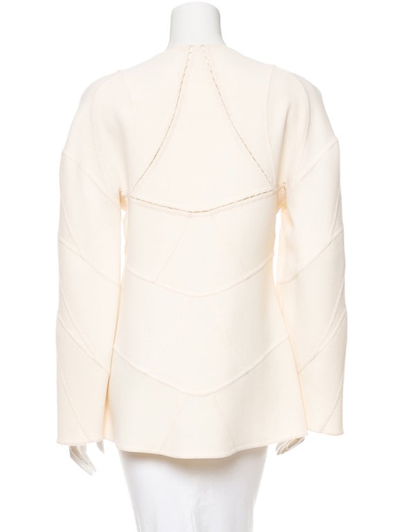 White woven wool Chado Ralph Rucci collarless jacket with seam and topstitch details throughout, slit pockets near hem and fabric button closures at front.
Condition: Excellent.
Measurements: Bust 36