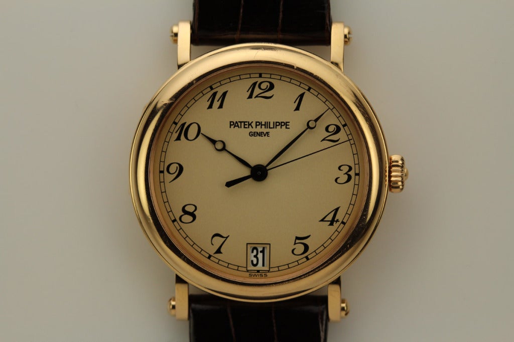 This is a beautiful Patek Philippe Officer's style Calatrava. The 36mm 18K Rose gold case features a hinged case back allowing a view of the movement. It has an ivory dial with breguet numerals and an automatic movement.
