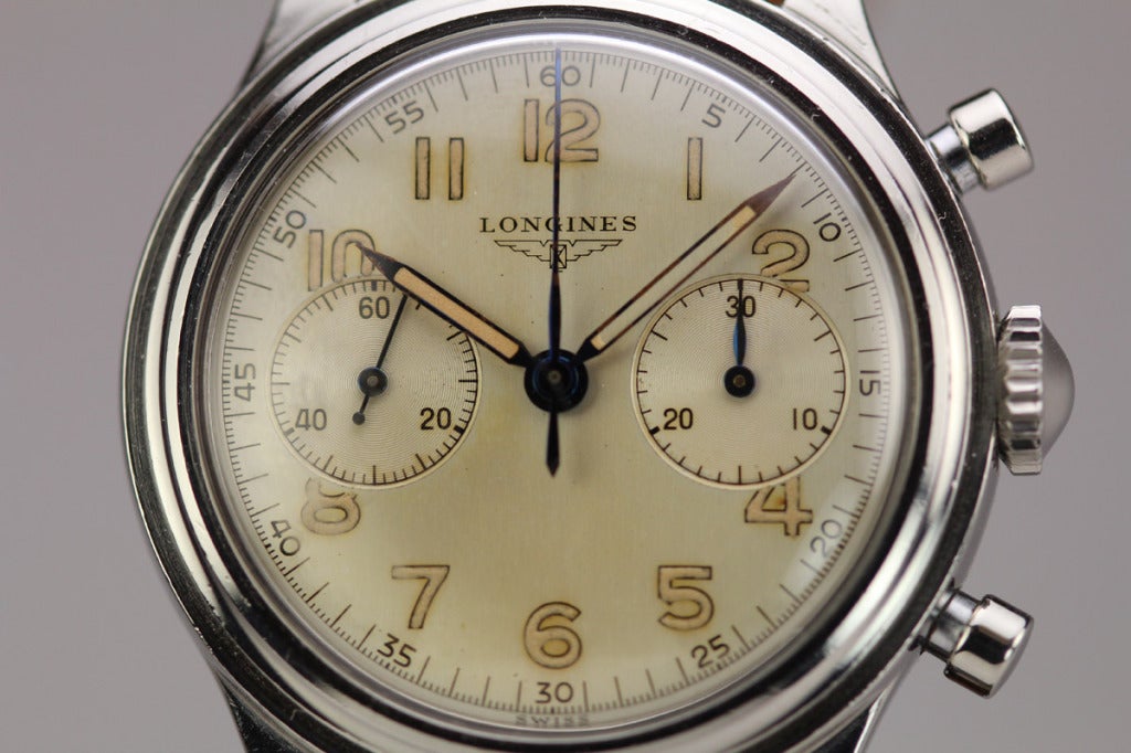 This is a great example of a stainless steel Longines chronograph from the 1950s, Ref. 6474 1. This watch has a mint original dial with beautiful patina. The case is also in excellent condition with very little wear. This chronograph is powered by