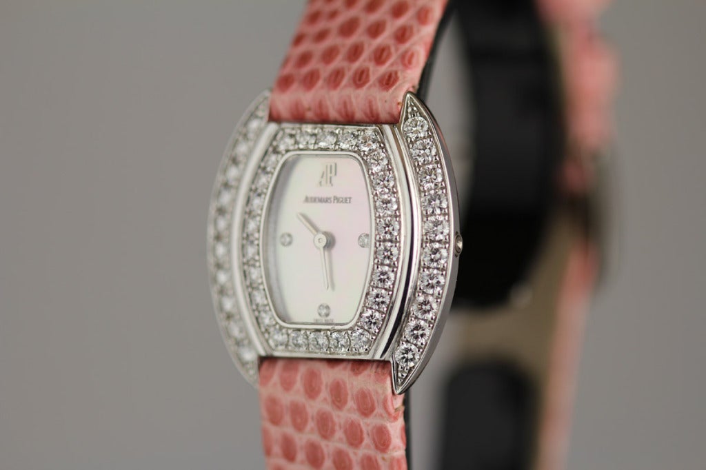 Audemars Piguet lady's 18k white gold and diamond tonneau wristwatch with mother-of-pearl dial. This has a quartz movement and is on a Audemars Piguet lizard strap and buckle.