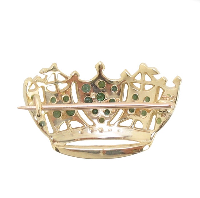 Beautiful Regal 14K Yellow Gold Tourmaline and Diamond Crown Pin Brooch, fashioned from the Merchant Marine emblem; old-style hook closure; set with 23 round facet-cut green tourmaline, fine intense green, measuring 1.3 to 2.1mm with an approximate