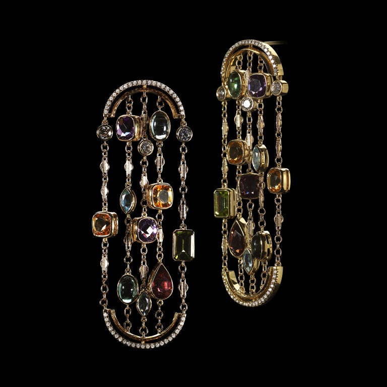 These arched earrings feature a mixture of Brillian and fancy shape Aquas, Citrines, Tourmalines, Amethysts and Peridots. Earrings are set in 18 karat yellow gold and suspended by arches detailed with Alexandra Mor's signature floating Diamond