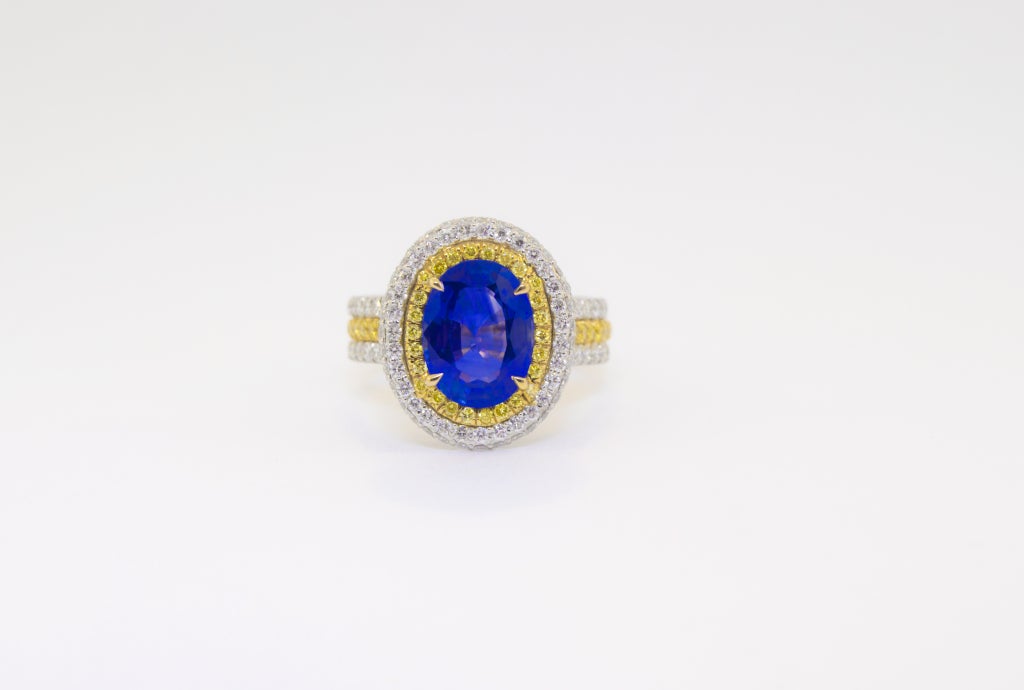 Platinum and 18K Yellow Gold ring with a stunning 3.03 Carat Ceylonese Sapphire with AGL Certificate.  Accented with Natural Canary and White Diamonds.