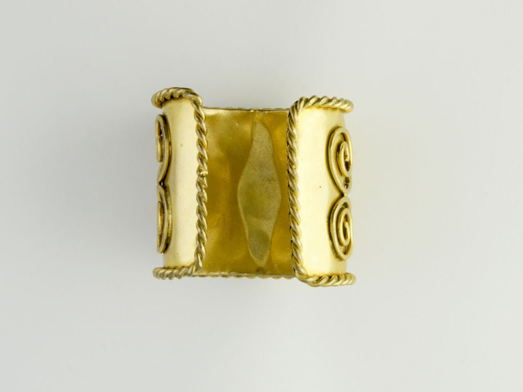 Indian bracelet by Isabel Canovas, gilded metal base with saldered circular decorative motifs and glass paste cabochon cut stones mounted simmetrically. Published in Farneti Cera D, Bijoux, Federico Motta editore, Milano, 2010 pag 352