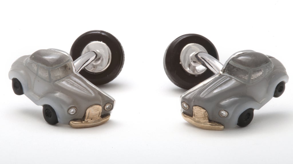 It would be difficult to create a more detailed, and more elegant, cufflink.  The body of this vintage automobile is carved from moonstone, while the tires are black onyx and the see through windows are rock crystal quartz.  To finish this miniature