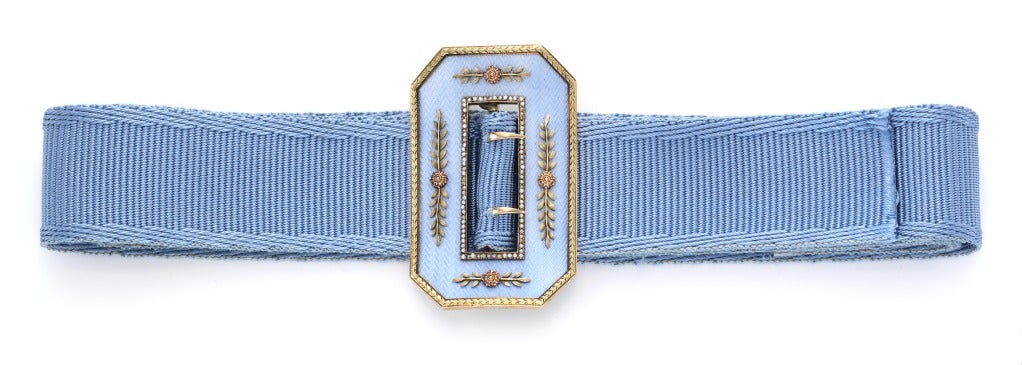Fabergé, A Gold-Mounted Guilloché Enameled Silver Belt Buckle, oblong, overall enameled in translucent blue over a wavy guilloché ground, within a gold border chased with rocaille scrolls, the central rectangular aperture with pearl-set border,