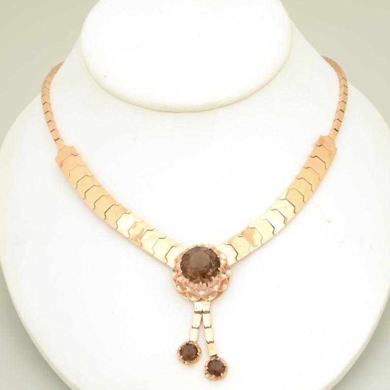 Retro 14k pink gold graduated snake link necklace with smoky topaz flower center and another 2 smoky topaz drops.

2