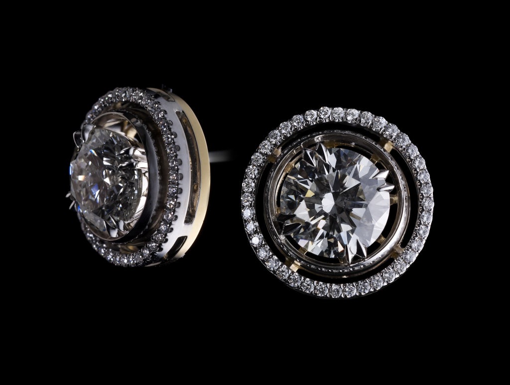 A pair of diamond stud earrings with Alexandra Mor Diamond knife edged signature Jackets. Center diamonds weigh a total of 1.5 Carats. Diamonds are Ideal cut and extremely bright. (Color: I, Clarity: VS1) Earring jackets contain Alexandra Mor