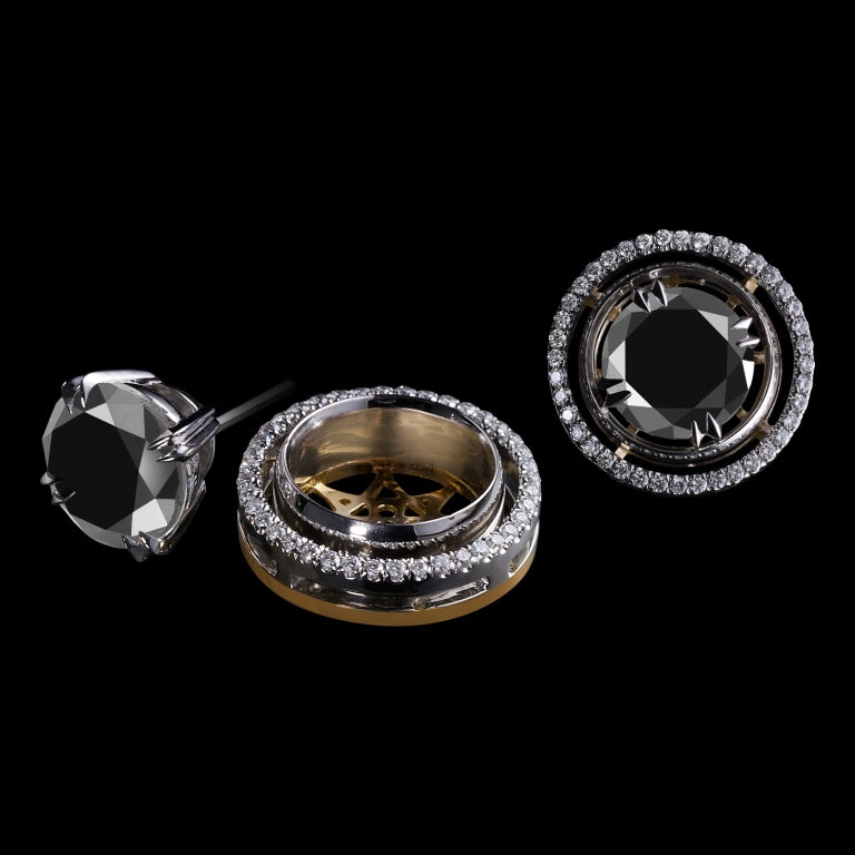 A pair of Round Black Diamond stud earrings accompanied by Diamond earring jackets detailed with Alexandra Mor's signature 1mm floating Diamond melee and knife-edged wire. Earrings measure 1/2 inch in diameter and are set in Platinum over an 18