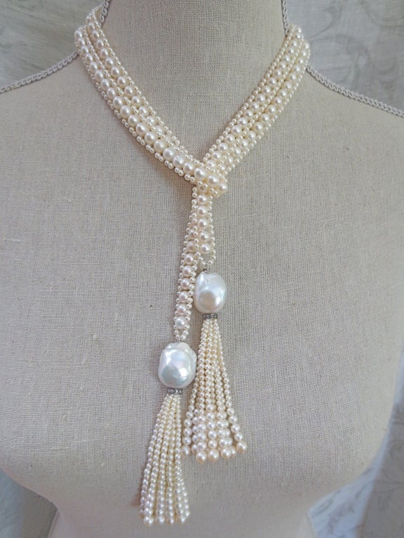 Extra-long flapper-inspired Large Woven Pearl Sautoir. 2.5 mm pearls and 6mm pearls provide a beautiful luster.  Large irregular shaped pearls accentuate the graduated tassels. Each tassel measures 3.75