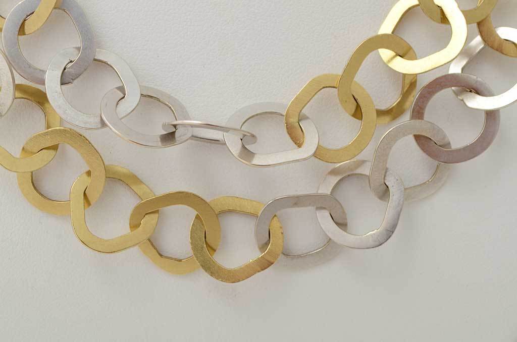 This long endless chain necklace by Bulgari alternates groups of five yellow with five white gold irregular links. They are intentionally out of round and each a little different. The chain is 34 1/2