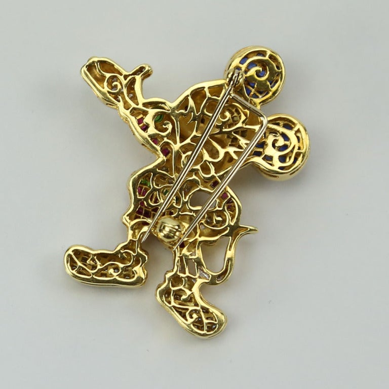 Fabulously Whimsical 18 karat yellow gold Pin encrusted with Diamonds, Rubies, Emeralds, and Sapphires. Forty-two diamonds weighing approx: .75ct.  Pin weighs approx. 14.9 dwt.  Approx. size: 1 1/2 in tall x 1 3/8 wide. The picture doesn't do