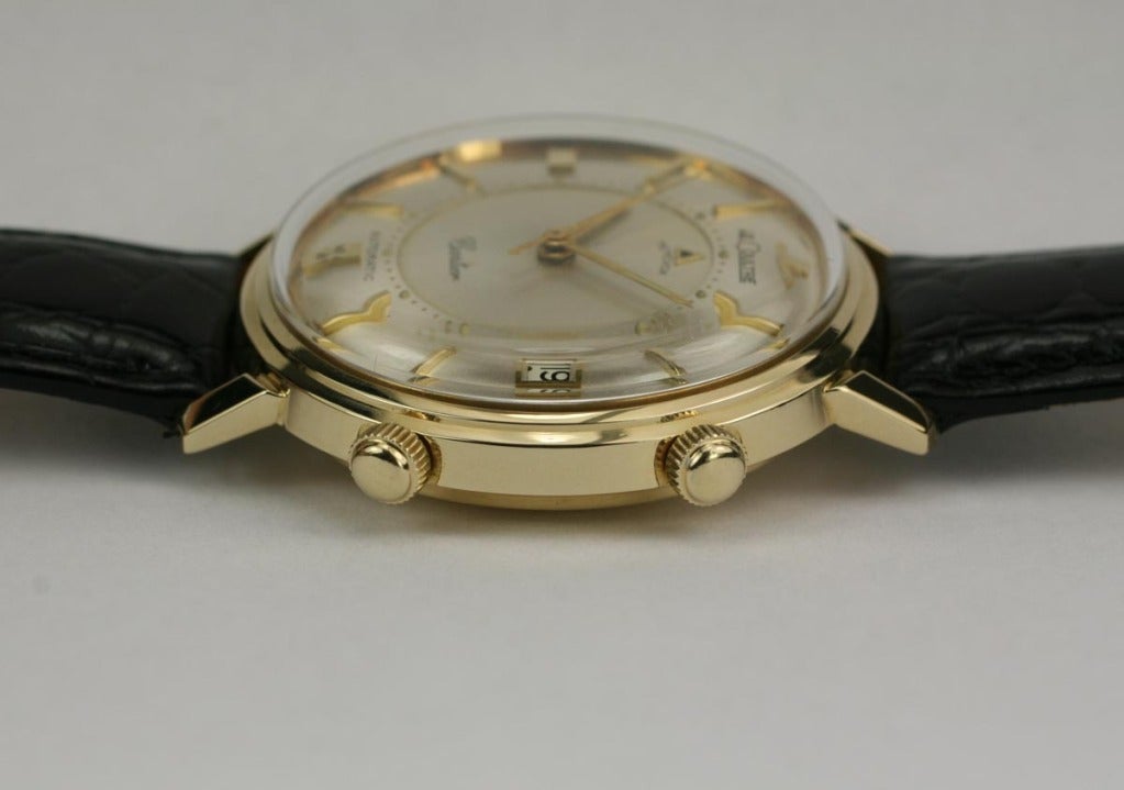 LeCoultre 14k yellow gold Memovox, retailed by Cartier. This is run using the LeCoultre caliber K825 17-jewel bumper automatic movement.