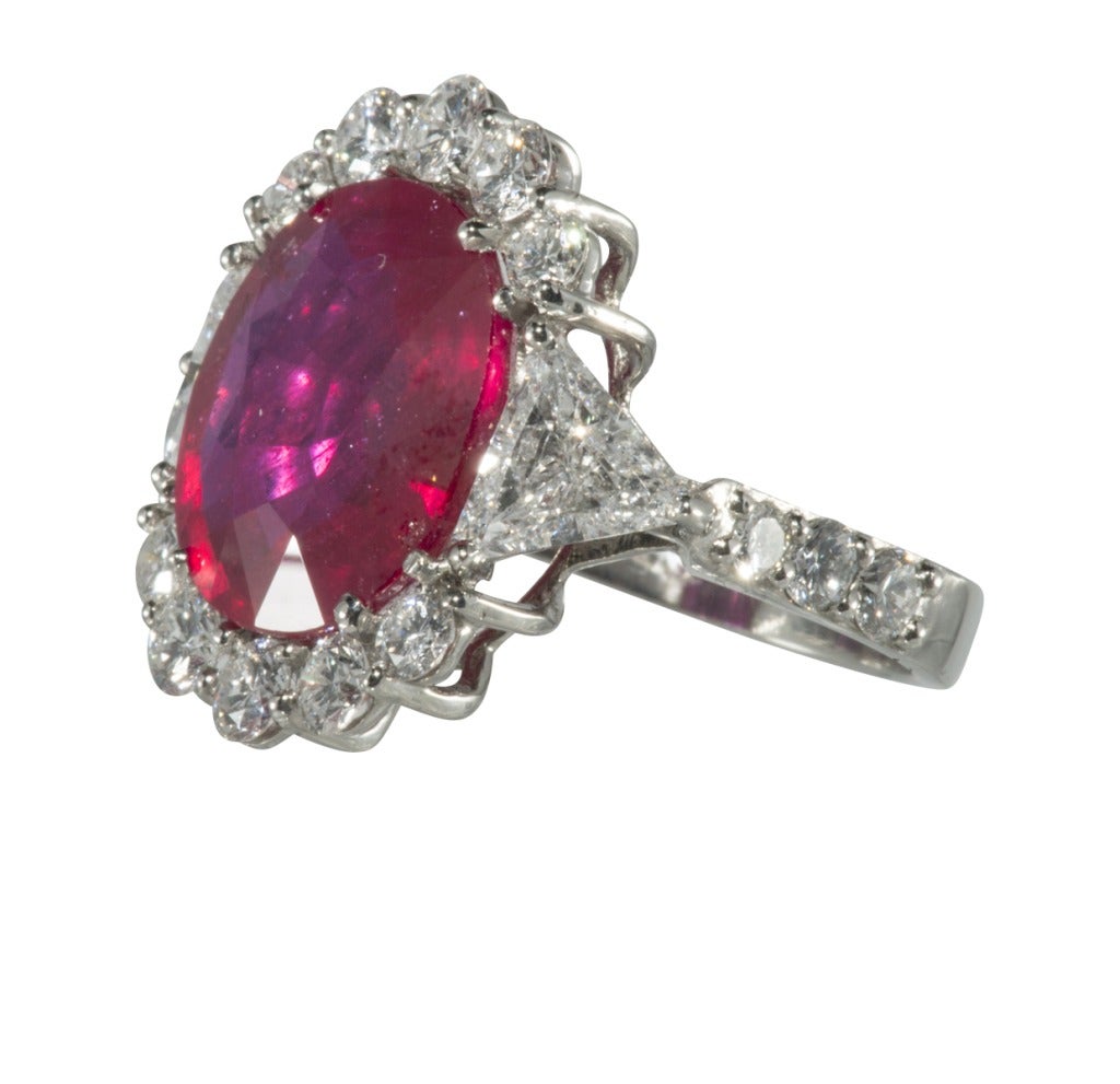 Platinum Oval 9.12 carat Ruby with a burmese-like color Surrounded by 3.15 carat diamonds