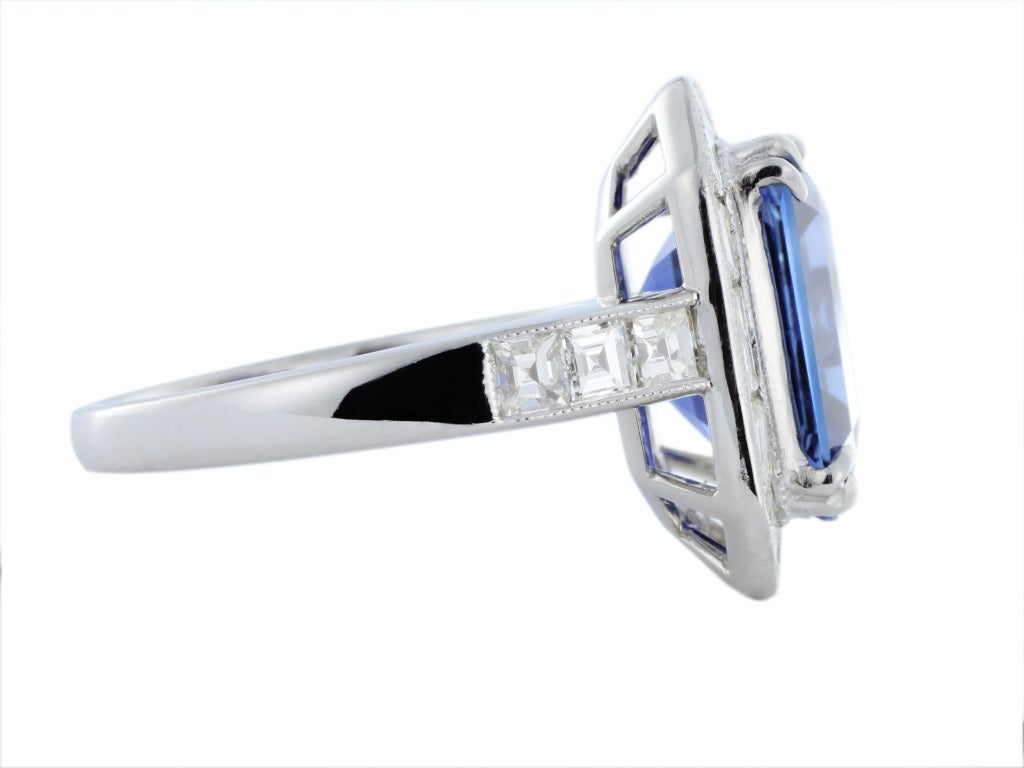 Platinum solitiare ring consisting of 1 emerald cut sapphire weighing 6.81 carat set with 1.96 carats total weight of baguette and asscher cut diamonds.