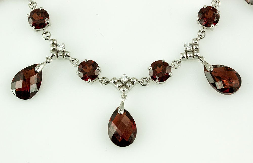 Elegant & Finely detailed Garnet and Diamond Fringe Necklace, featuring five Garnet drops; each drop holding one teardrop facet-cut deep red Rhodolite Garnets inter-spaced with four round facet-cut deep red Rhodolite Garnets and five diamonds in a