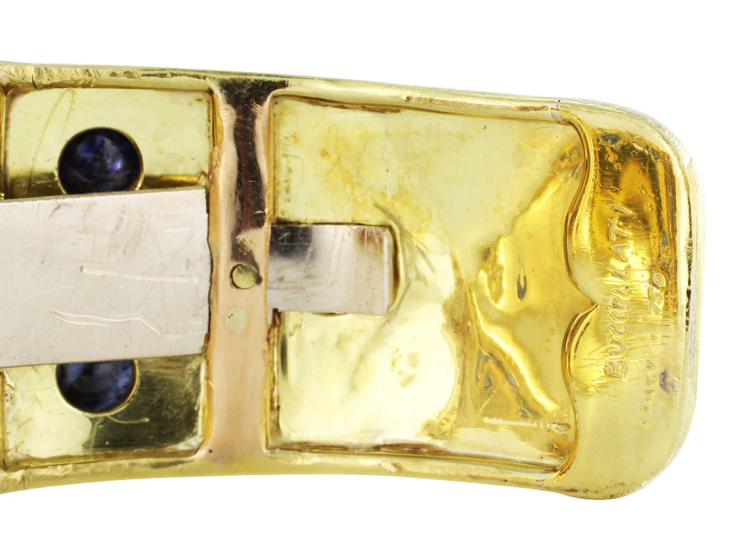 18 karat yellow gold cuff bracelet set with cabochon sapphire accents, signed Buccellati.