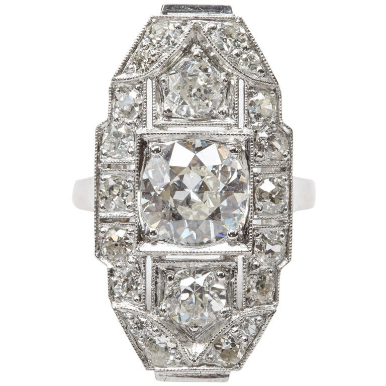 An Art Deco diamond ring of architectural geometric design and open work gallery, set with 21 intermediate brilliant cut diamonds with a total weight of ca. 2.12 ct. The central stone is estimated at 1.35ct. Ring size15Â¾ / 4 Â¾.
