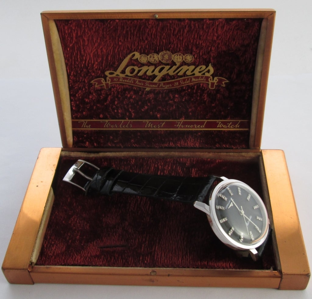 PLEASE NOTE: OUR PRICE IS FULLY INCLUSIVE OF SHIPPING, IMPORTATION TAXES & DUTIES

14k white gold Longines automatic wristwatch with black dial and diamond indexes, circa 1950s, with a screw down waterproof back.

Automatic movement, cal 19AS,