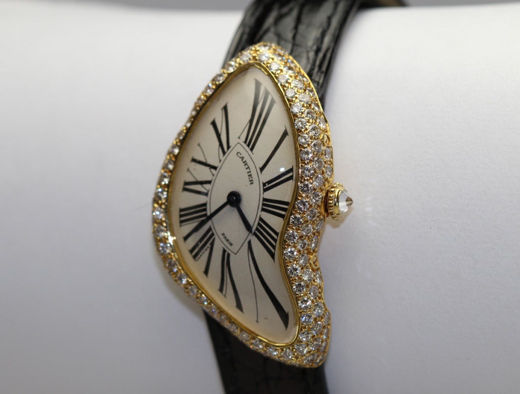 This is an extremely rare version of the Cartier Crash from early 1990s, signed Cartier, Paris. What makes it so rare are the diamonds. Typically the crash models from this period did not have  diamonds but this particular version does. This is a