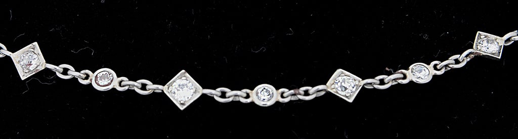 Platinum diamond by the yard chain with 59 diamonds set in interchanging round bezel and prong set in diamond shaped plaque.  This is a unique design.