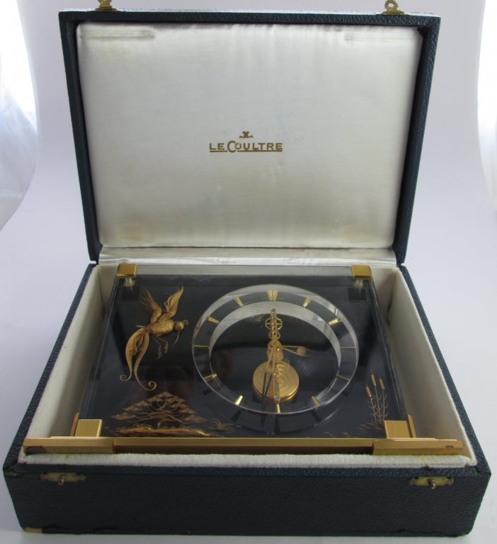 Jaeger-LeCoultre Bird of Paradise desk timepiece. Made circa 1960. Fine and rare, brass and Lucite, 8-day movement.




C. Rectangular Lucite Bird of Paradise panel held by four brass screws mounted on a stepped rectangular brass base. D.