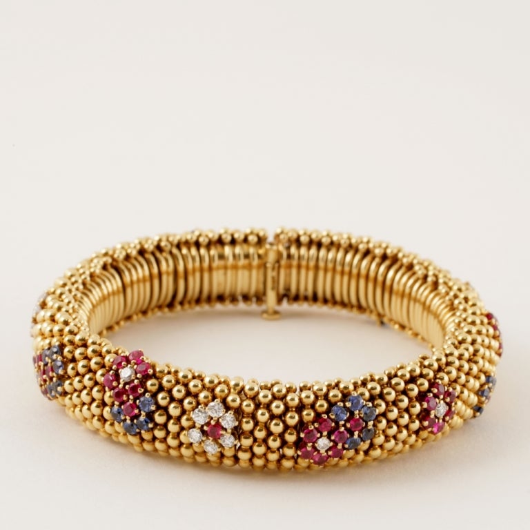 A French 18 karat gold bracelet with rubies, sapphires and diamonds by Van Cleef & Arpels. The bracelet is named 